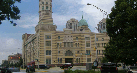 A distant view of the Old National Centre with tower on the corner of an intersection.