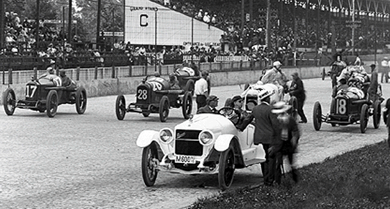 Several antique cars with their drivers on the Motor Speedway track in 1916.