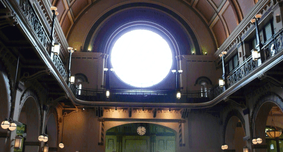 The inside of the Indianapolis Union Station lobby, looking up to the sun filled rose window.