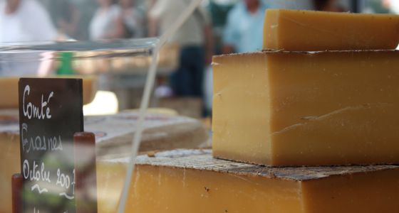 A close-up of cheese in a display case.