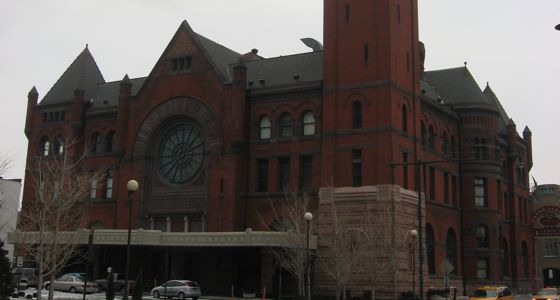The outside of the Indianapolis Union Railroad Station with rose window and clock tower feature.