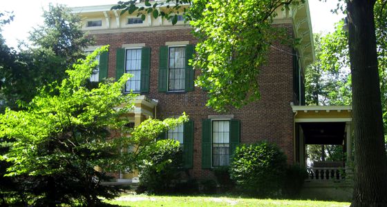An outside view of the Hanna Ochler Elder House, a brick house with window shutters.