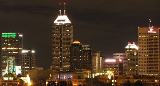A distant view of the Indianapolis city skyline at night.