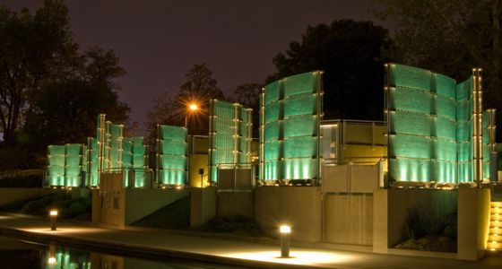 The Medal of Honor Memorial lit by lamps at night.