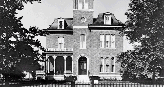 A view of the Morris Butler House, a three-story brick home with a tower.